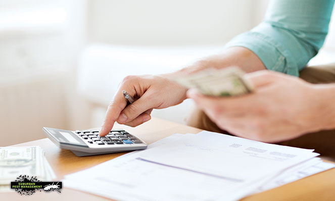 image of person with calculator, cash and paperwork